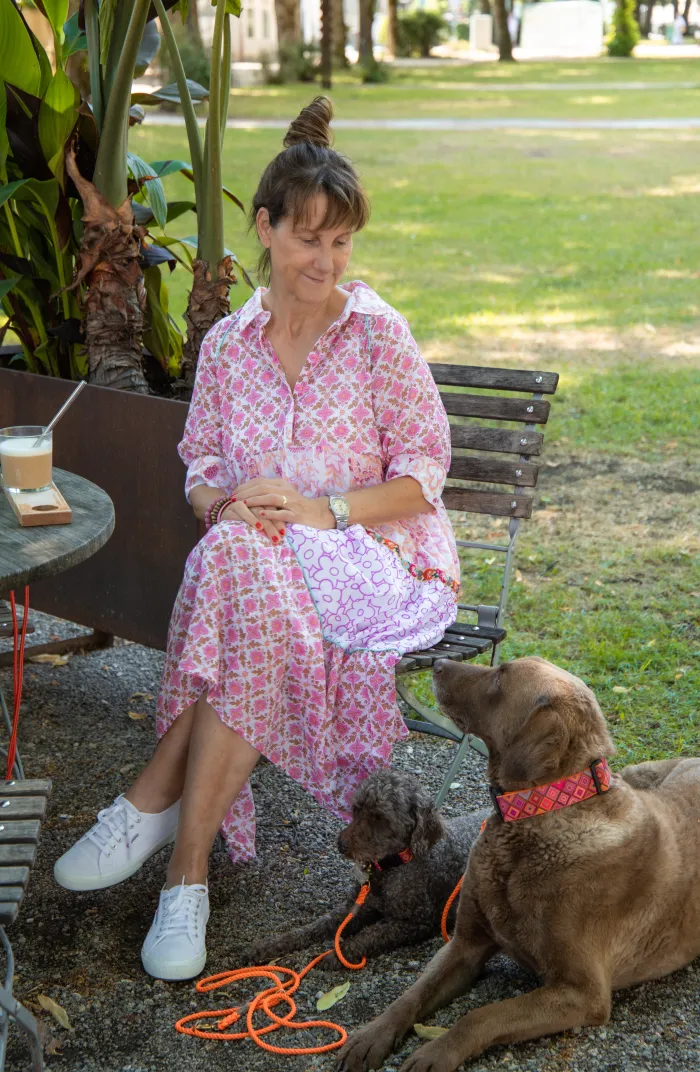 Petra Dürr sitzt im Café, ihr Hund liegt neben ihr